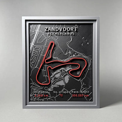 Framed map of Zandvoort circuit with red track layout on a gray background