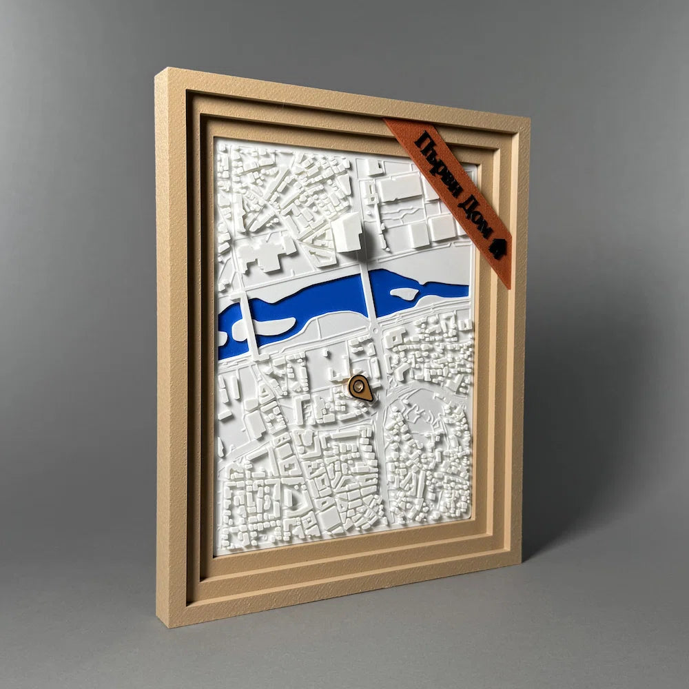 Framed topographic map with a location of a first home