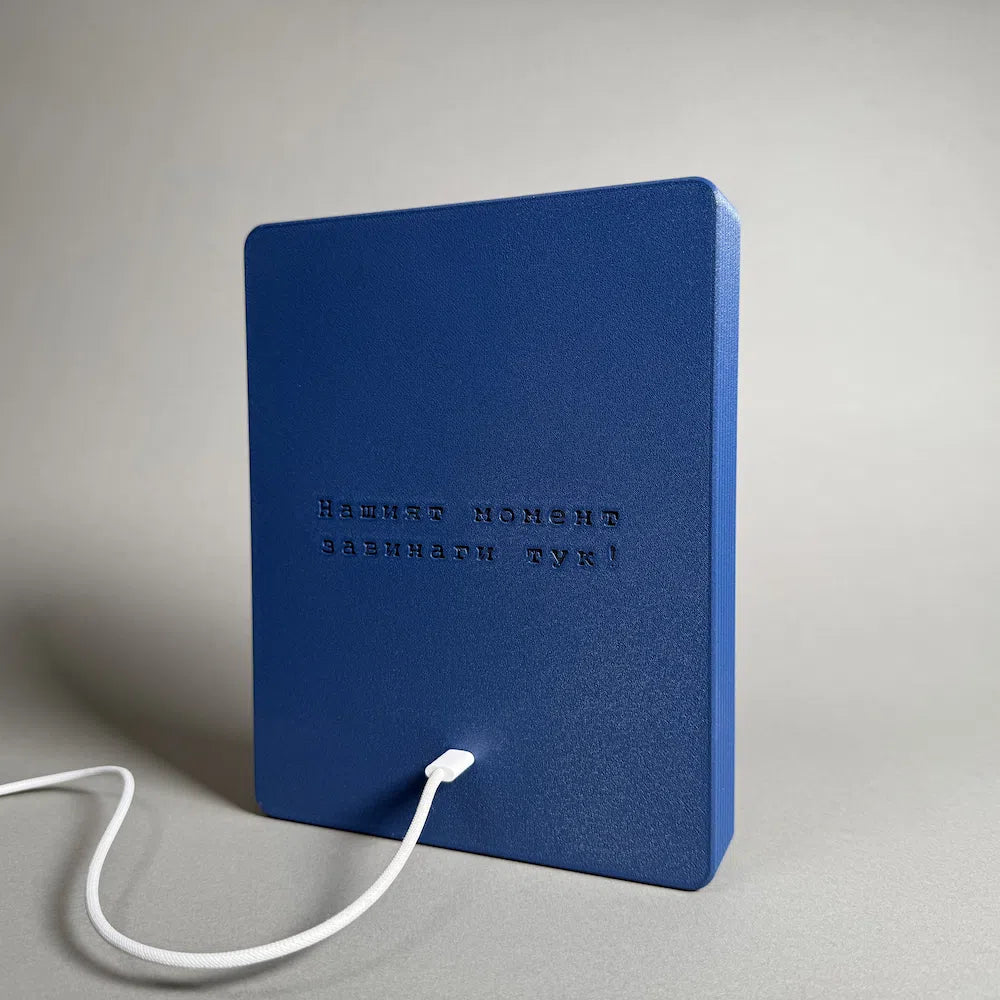 the back of a plugged in litophane frame in blue